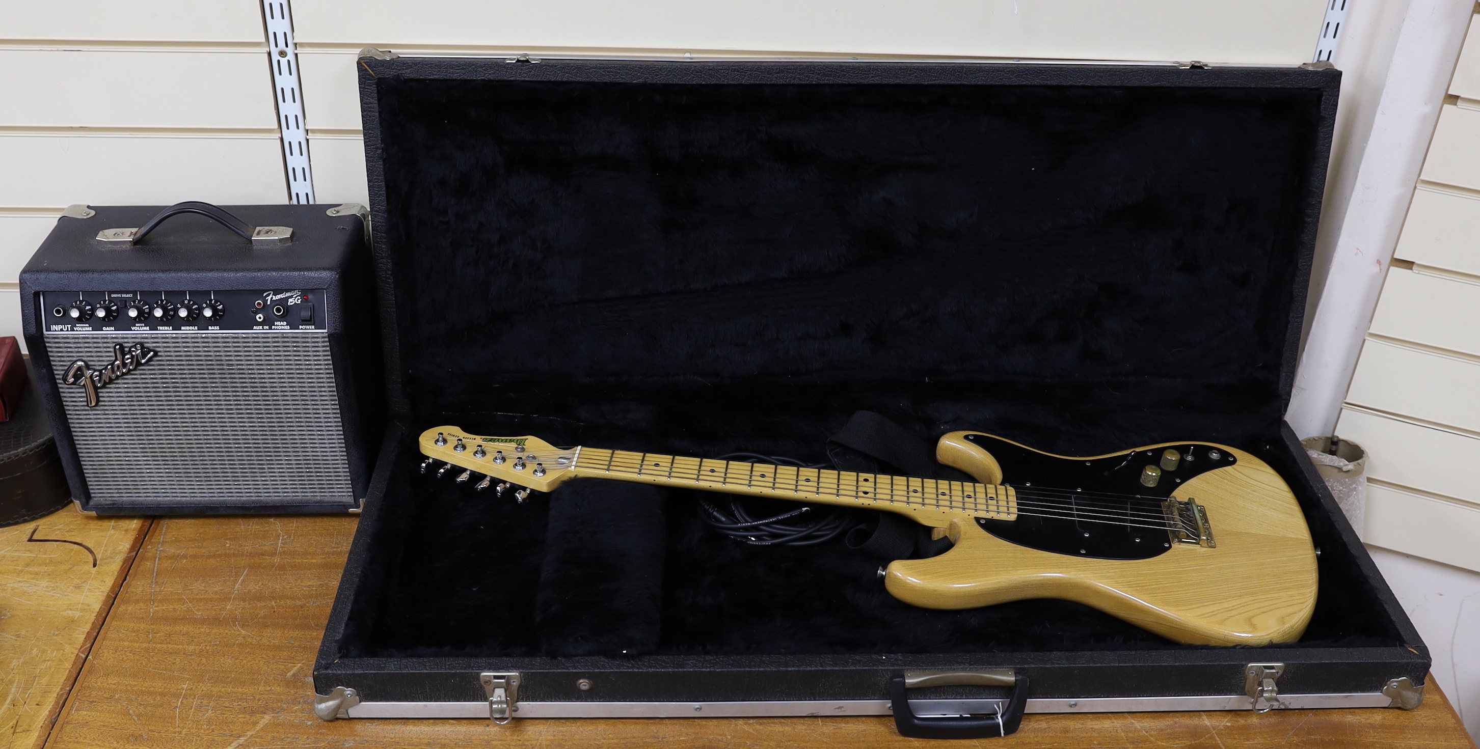A 1980 Electric guitar by Ibanez, Japan, Blazer Series in natural finish with flight case and a small Fender Frontman 15G amp